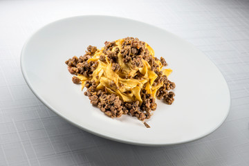 Elegant White round bowl with tagliatelle Bolognese