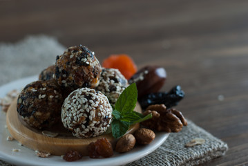 Energy Balls and ingredients for snack on a wooden plate