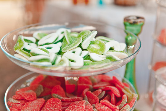 Fruit sweets on a glass stand, candy and oriental sweets, treat at a summer picnic, selective focus