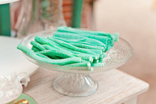 Fruit sweets on a glass stand, candy and oriental sweets, treat at a summer picnic, selective focus