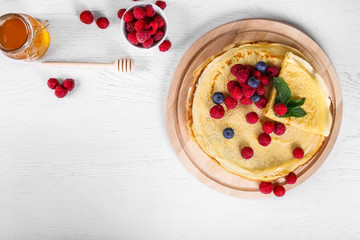 Top view of pancakes with raspberries and blueberries. Healthy summer breakfast,homemade classic...