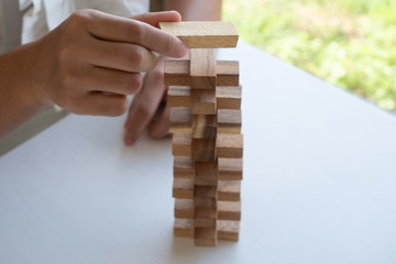 hand playing blocks wood game, gambling placing wooden block. Concept Risk of management and strategy plan, growth business success process