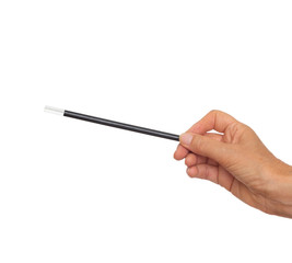 Female hand with traditional magician's black and white magic wand isolated on white background.