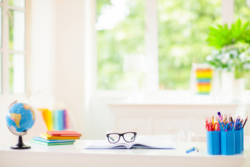 Back to school. Kids desk with books, globe.