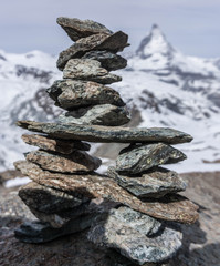 Pile of stones (cairn) at the gornergrat with the matterhorn mountain in the background