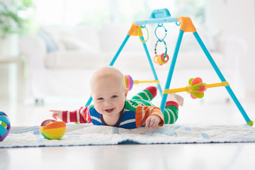Baby boy with toys and ball