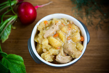 stewed potatoes with vegetables, cabbage and meat in a bowl