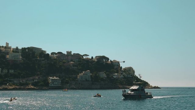 A lot of boats in the sea. nlue sky and rocks in France.