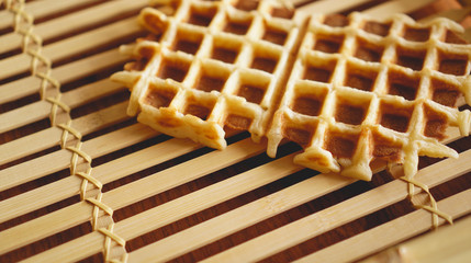 Sweet fresh Viennese waffles on rustic wooden background. Selective focus, horizontal.