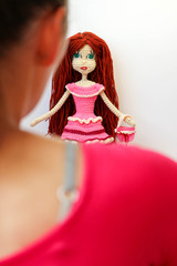 Master and her creation girl in red dress with knitted crochette doll