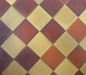  Old shabby square ceramic floor tiles (mettlach tiles). Background texture. Diagonal chequered pattern. Top view. 