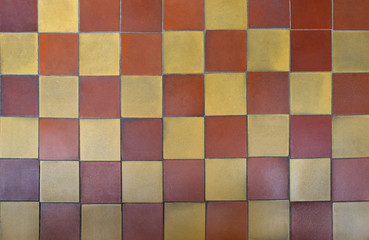 Old shabby square ceramic floor tiles (mettlach tiles). Background texture. Chequered pattern. Top view. 