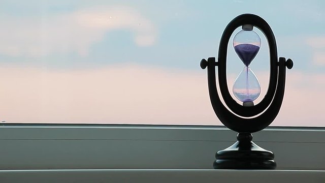 sunset sand clock hand window background 