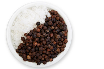 Bowl of black pepper with salt on white