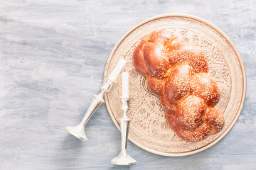 Shabbat or Sabbath kiddush ceremony composition with a traditional sweet fresh loaf of challah...