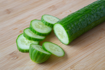 Cucumbers cut on a cutting Board. Background. Close up. Vegetables, healthy, proper nutrition.