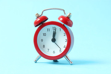 mechanical alarm clock on a colored background