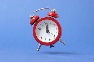 mechanical alarm clock on a colored background