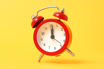 mechanical alarm clock on a colored background