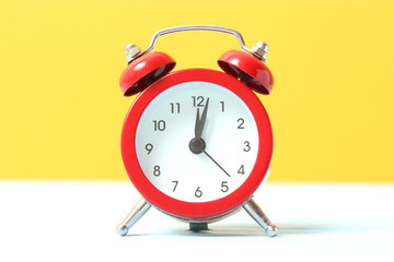 mechanical alarm clock on a colored background