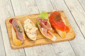 Tapas - bruschetta with prosciutto, salmon, duck and gorgonzola
