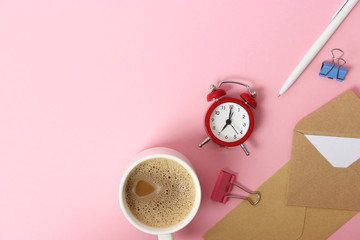 alarm clock and coffee on a colored background top view.