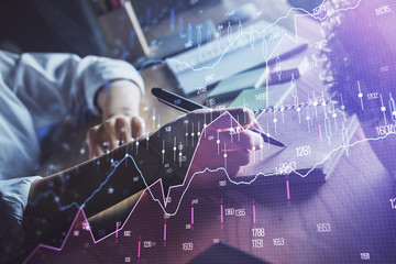 Financial forex charts displayed on woman's hand taking notes background. Concept of research. Double exposure