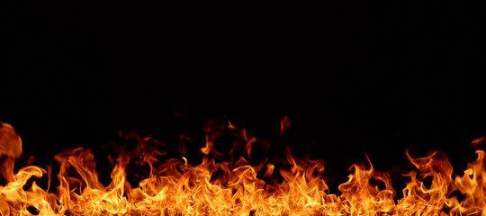 A red flame that is burning on a black background.