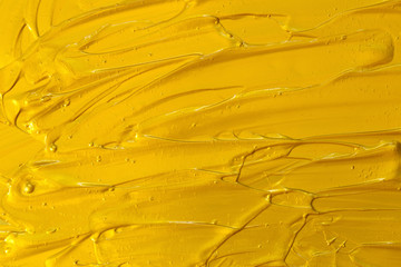 Golden acrylic texture, wave, abstract background.