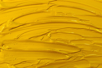 Golden acrylic texture, wave, abstract background.