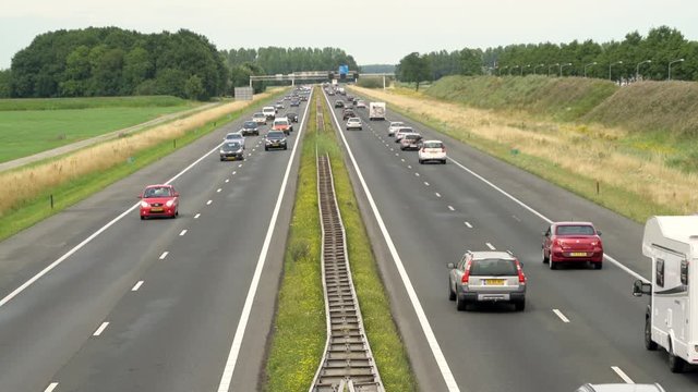 Traffic passing by on a wet summer day on the A28 Highway from Zwolle to Amersfoort, Nijkerk, The Netherlands July 20th 2019