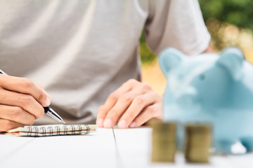 businessman Writing paper and using calculator Calculating bonus(Or other compensation) to employees to increase productivity. on desk.Selective Focus