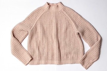 Obraz premium Sweater on a white background top view.