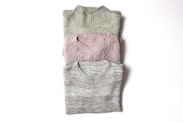 sweaters on a white background top view