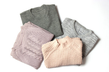 sweaters on a white background top view