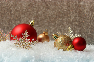 Christmas balls and snow on a colored background. Christmas and New Year background.