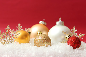Christmas balls and snow on a colored background. Christmas and New Year background.