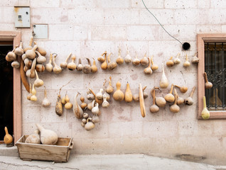 Dried bottle gourds, calabashes hanging on the stone wall