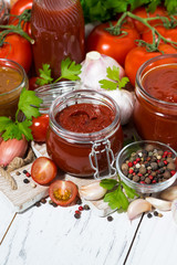 tomato sauces, pasta and fresh ingredients on  wooden background, vertical top view