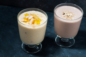 two servings of milkshake in glasses, top view