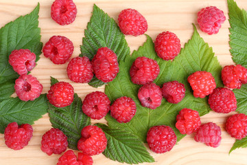 Raspberries, berries and leaves, top view. Berry backdrop.