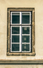 Fototapeta na wymiar Old window in ancient facade
