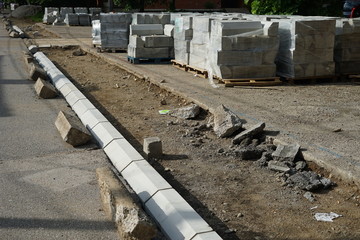 Reconstruction of the sidewalk and replacement of old curbs. Construction zone