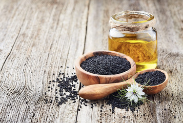 Black cumin oil with seeds and flower nigella sativa