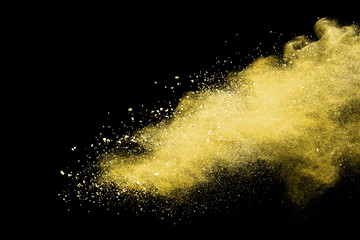Yellow powder explosion on black background. 