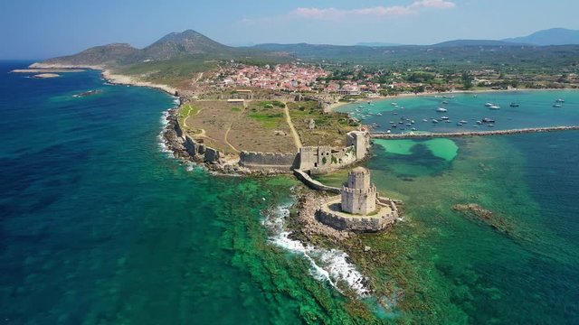 Aerial drone video of iconic Venetian tower of Bourtzi and medieval fortified castle in picturesque village of Methoni, Messinia, Peloponnese, Greece