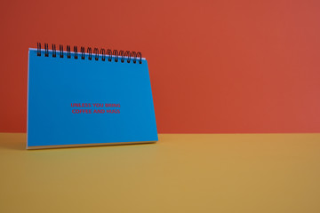  Colorful background with a notebook on top of a table and a notebook. Contemporary and youth design.