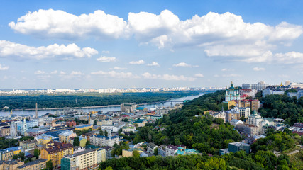 Aerial top view of Saint Andrew's church and Andreevska street from above, cityscape of Podol district on sunset, skyline of city of Kiev (Kyiv), Ukraine