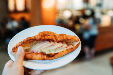 Handed Dish of Croissant Ham Cheese