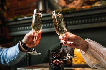 Glasses with champagne in the hands of a beautiful wedding couple. Celebration, wedding concept, new family.